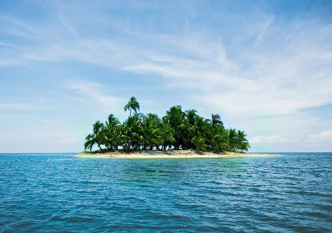 Placencia Peninsula beach in southern Belize with palm trees and white sand